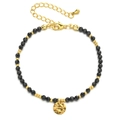 Detail of beaded bracelet featuring black faceted stones and gold hammered pendant charm - Black