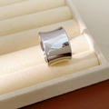 Macro shot of polished wide silver open ring placed on a beige velvet jewelry box - Silver