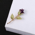Detailed close-up of a 3D enamel rose brooch with purple petals and green leaves - Purple Rose