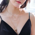 Detail of bohemian layered necklace with gold coin pendant, white pearls and shell charm - NZ363-Gold Natural Shell