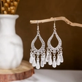 Close-up of bohemian hollow teardrop earrings with silver leaf tassel charms on wood - Silver Hollow Drop Tassel Style 4(E2875-09)