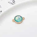 Gold plated circular resin charm with iridescent teal blue glitter and dual loops - Light Blue