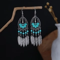 Detail of silver bohemian dangle earrings with blue beads and metal feather tassels - Sky Blue Floral Feather Style (E6136-1)