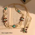 Detail of bohemian hand-woven waist chain with turquoise stones and wooden beads on book - Bohemian Woven (HN8555) / White-Blue