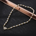 Detail of white pearl and gold bead necklace with a sparkling heart pendant centerpiece - XL21 / Heart Pearl / Pearl Gold