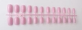 Detail of 24-piece long square pastel pink press-on nails on a plastic sprue connector - Pastel Pink (CFL-20)