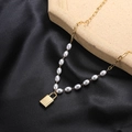Elegant titanium steel necklace featuring a golden padlock pendant and white oval pearls - Gold Lock Pendant Pearl Necklace