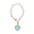 Detail of pearl cup charm with light blue heart pendant featuring golden letter C - Letter C