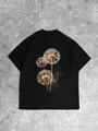 Oversize black cotton T-shirt featuring a detailed dandelion print on a stone background - S / Black