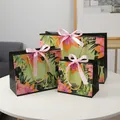 Three sizes of tropical hibiscus gift bags with pink silk bows and gold rope handles - S / Pink Ribbon