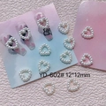 Macro shot of 12x12mm heart-shaped resin pearl nail art charms on a decorative card - Heart