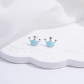 Macro view of silver crown earrings with light blue enamel finish on white tray - Blue Crown