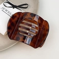 Macro detail of tortoiseshell hair clip with hollow stripes on a decorative plate - Large Deep Tortoise