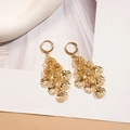 Detailed view of gold shell earrings with layered crystals on white tulle background - Hoop Earrings-Gold