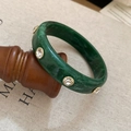 Detail of emerald green marble resin bracelet with inlaid crystals and gold metal frames - Dark Green White