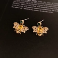 Macro detail of gold bee earrings with yellow, green and clear crystals on vintage book - Gold Bee Three-Color Gemstone Studs (5#)