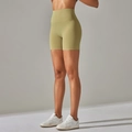 Side view of avocado green high-waisted fitness shorts with wide slimming waistband - Olive Green