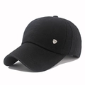 Dettaglio del cappellino nero in cotone con una placchetta metallica argentata laterale - Nero