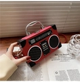 Detail of red vintage radio-style handbag featuring silver handle and speaker patterns - Red