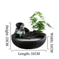 Zen style black ceramic indoor water fountain with monk figurine and green plant decoration - Carefree Monk Black Style