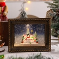 Detalle del marco de bola de nieve navideña vintage con una escena de familia de muñecos - Muñeco de Nieve