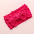 Macro detail of the rose red cable knit texture and soft bow on the infant nylon headband - Rose Red