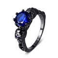 Macro view of S925 engraved stamp inside a gothic skull ring with blue gemstone - Blue
