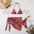 Detail of a 3-piece floral bikini set featuring a hibiscus print and matching mesh sarong - Red Brown