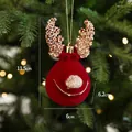 Red flocked Christmas reindeer ornament with champagne gold sequins on warm tree background - Red Flocked Cute Reindeer