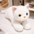 Realistic white plush cat with heterochromia blue and amber eyes in a lying pose - White Cat