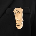 Abstract golden face brooch on black blazer lapel featuring modern artistic minimalist design - KC Gold