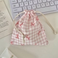 Pink checkered drawstring pouch with red bow patterns on a clean desktop scene - Pink Gingham Bow (Small)
