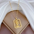 Macro shot of gold-plated portrait pendant with zircon border on white silk - Portrait Cameo Pendant (J106)