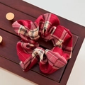 Close-up of a red plaid scrunchie displayed on a dark wooden jewelry box surface - Red Plaid - Plain