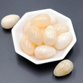 Polished egg-shaped pale yellow agate gemstone displayed in a white octagonal dish - Cream Jade (1pc)