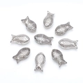 Macro detail of silver fish-shaped glass beads with textured scales for DIY jewelry making - Smoke Gray