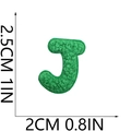 Macro shot of green Chenille letter J patch with embroidered edges and terry texture - Letter-J