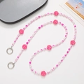 Detailed view of pink and white beaded phone strap with flower charms and silver metal clasps - Rose Red Flower Beads