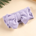 Close-up of soft lilac knit baby headband featuring a delicate large double bow texture - Purple