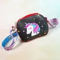 Close-up of black unicorn kid's crossbody bag with wide printed strap and gold hardware - Red