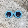 Detail of blue flower-shaped kids sunglasses with UV400 protection and CE mark - Glossy Sky Blue