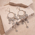 Silver wrinkled metal geometric round tassel earrings displayed on natural stone - Silver