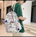 Detail of waterproof graffiti backpack featuring THE NIGHT text and a cute duck pendant - With Duck Charm / Gray