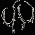 Silver magnetic couple bracelets with astronaut pendants on a black velvet background - Astronaut Bracelet Pair / 1 Pair Pack