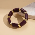 Détail de blocs en résine violette et maillons dorés sur un bracelet de style ethnique - Violet