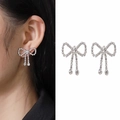Elegant asymmetrical bow tassel earrings with sparkling crystals in silver finish - Silver (A1117)