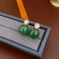 Elegant gold earrings with sparkling white zircon and round green agate stones on gray velvet - Green Round Bead Studs / Gold with Green