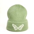 Close-up of a light green ribbed knit beanie featuring a white butterfly pattern on cuff - One Size (Elastic) / Light Green