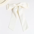 Close-up of elegant cream white satin bow hair clip with long flowing ribbons - White