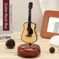 Vintage guitar music box on rotating wood base measuring 9.5x9.5x21cm for home decor - Guitar Style (YL2050)